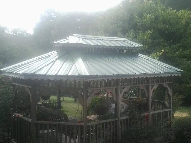 Two tier green metal roof on a garden gazebo in Siletz
